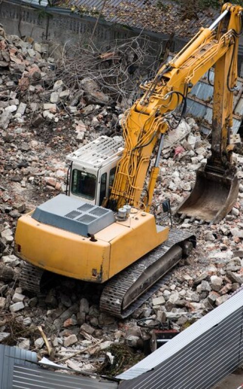 construction-site-cran-tractor-destroying-building_1268-12904